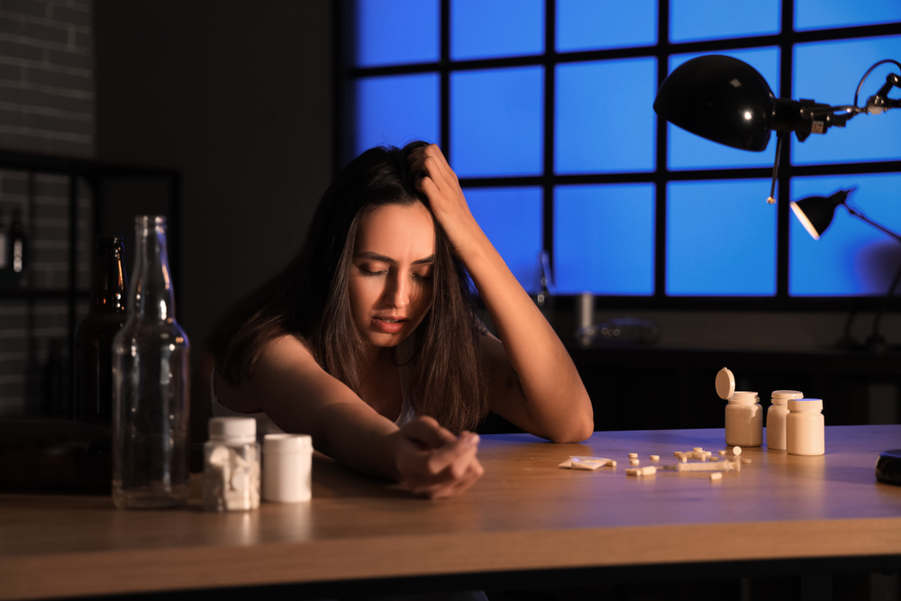Woman dealing with substance use disorder in a dimly lit room