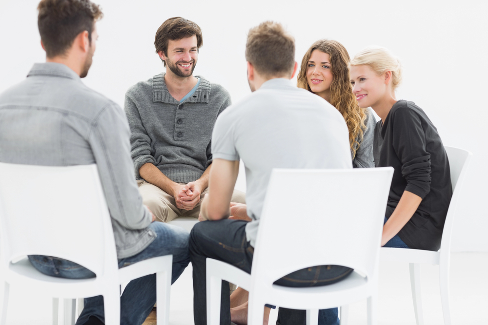 patients with substance abuse disorders gather for a group session