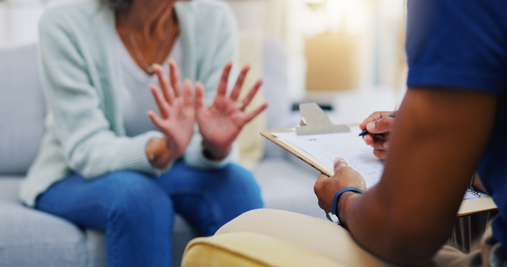 person raising her own hands as a sign of surrendering her addiction to the addiction treatment