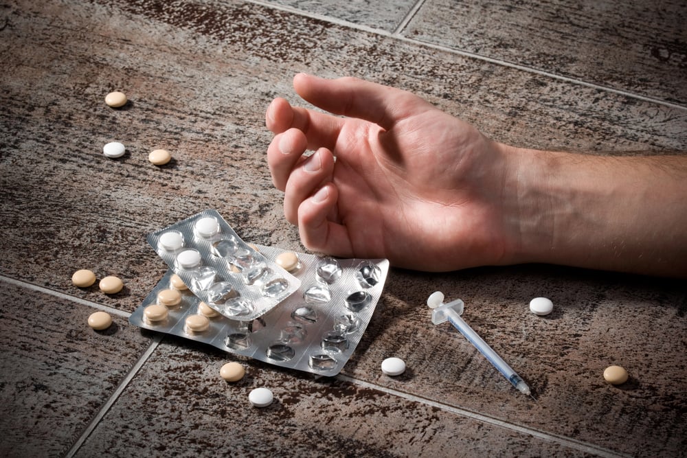 man overdosing on drugs and just fallen dangerously