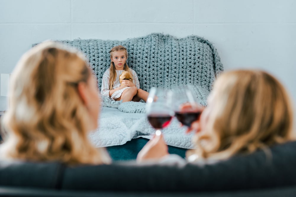 child looking at her alcoholic mom and aunt