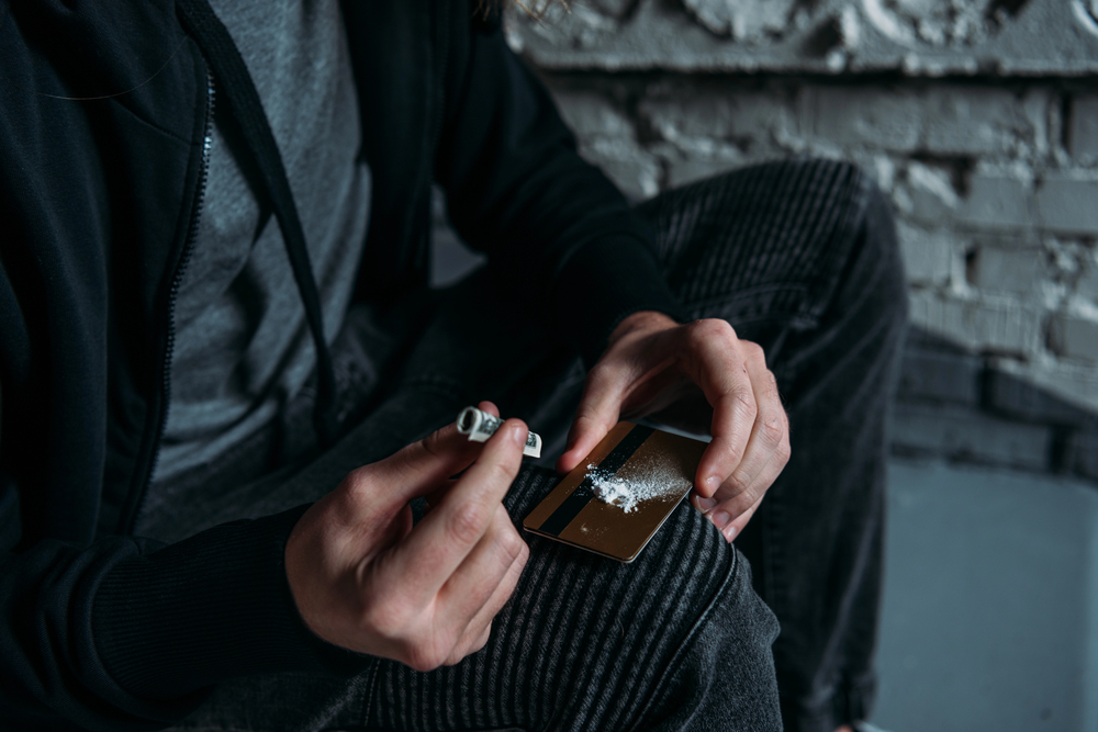 man with cocaine addiction taking a huge dose of it