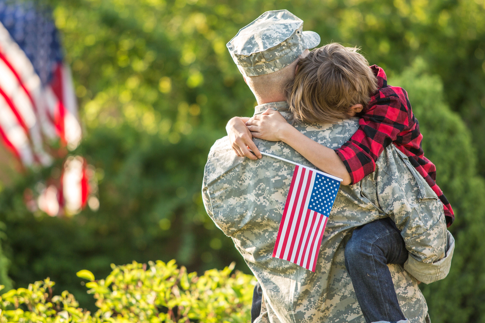 child hugging her soldier father who she knows is suffering from PTSD