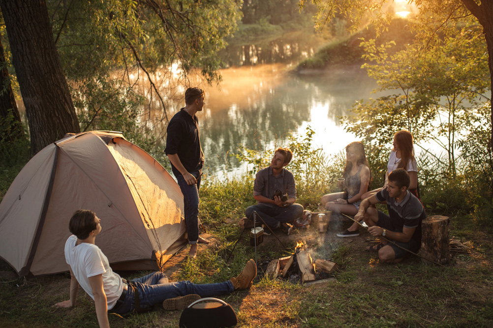 a group of people are spending great time in the picturesque place in the evening trying to escape the reality