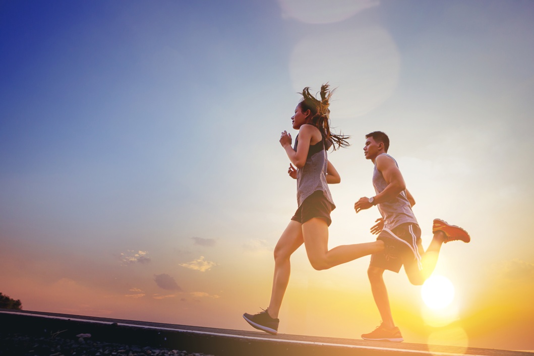 Fit runner fitness runner during outdoor workout with sunset background