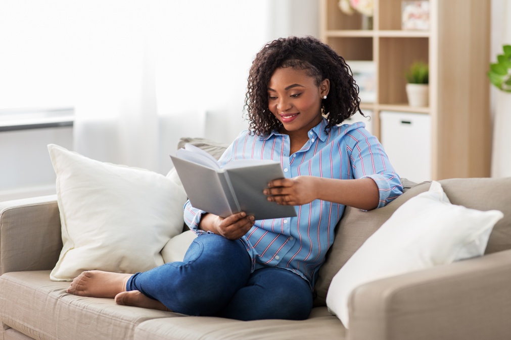 happy woman reading book at home